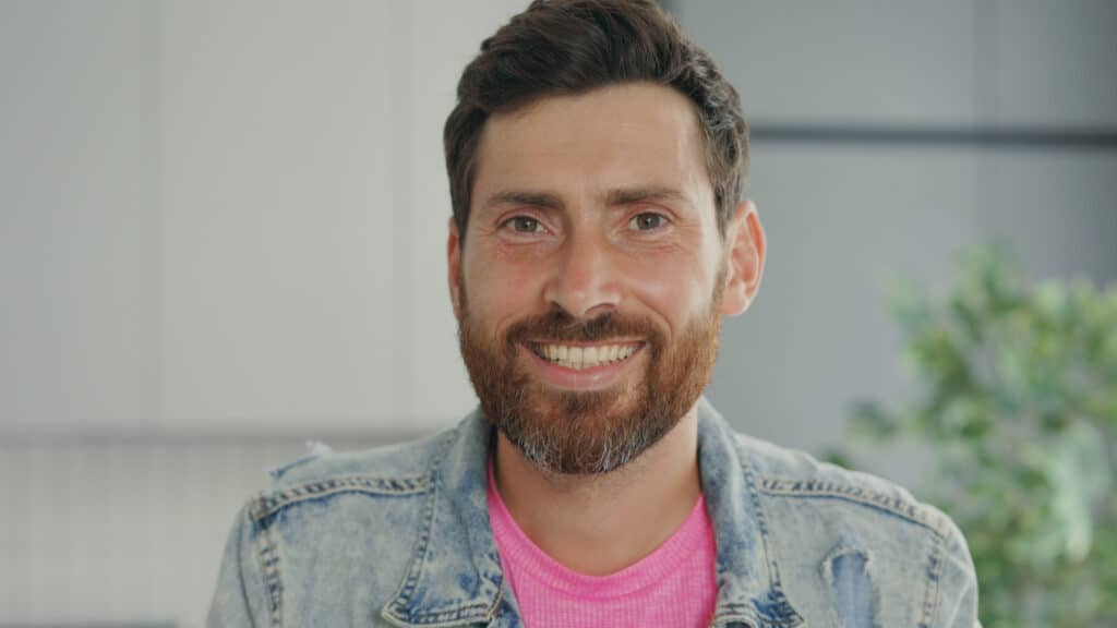 close-view-of-the-smiled-man-looking-at-the-camera-portrait-of-the-handsome-middle-age-SBI-350928839